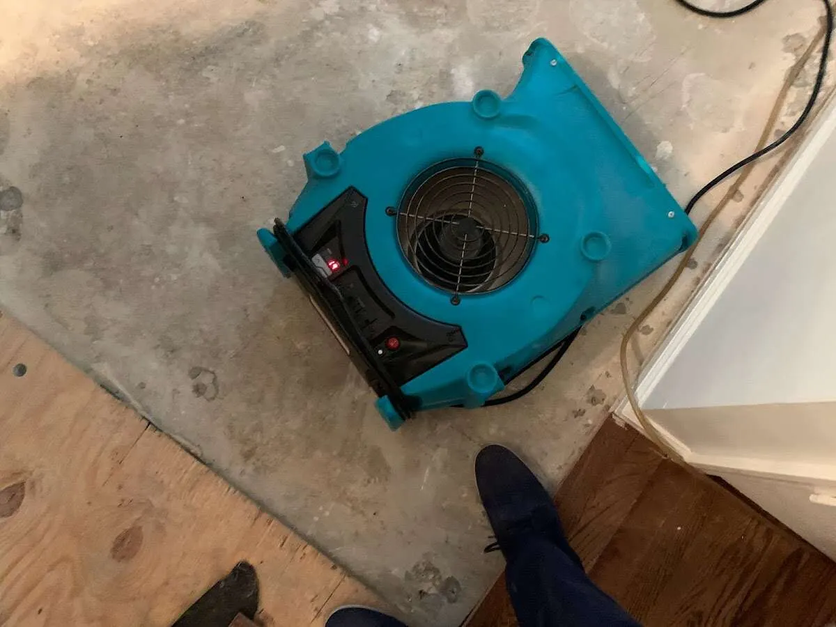 Air mover drying subfloor during Commercial Water Damage Restoration in Rusk